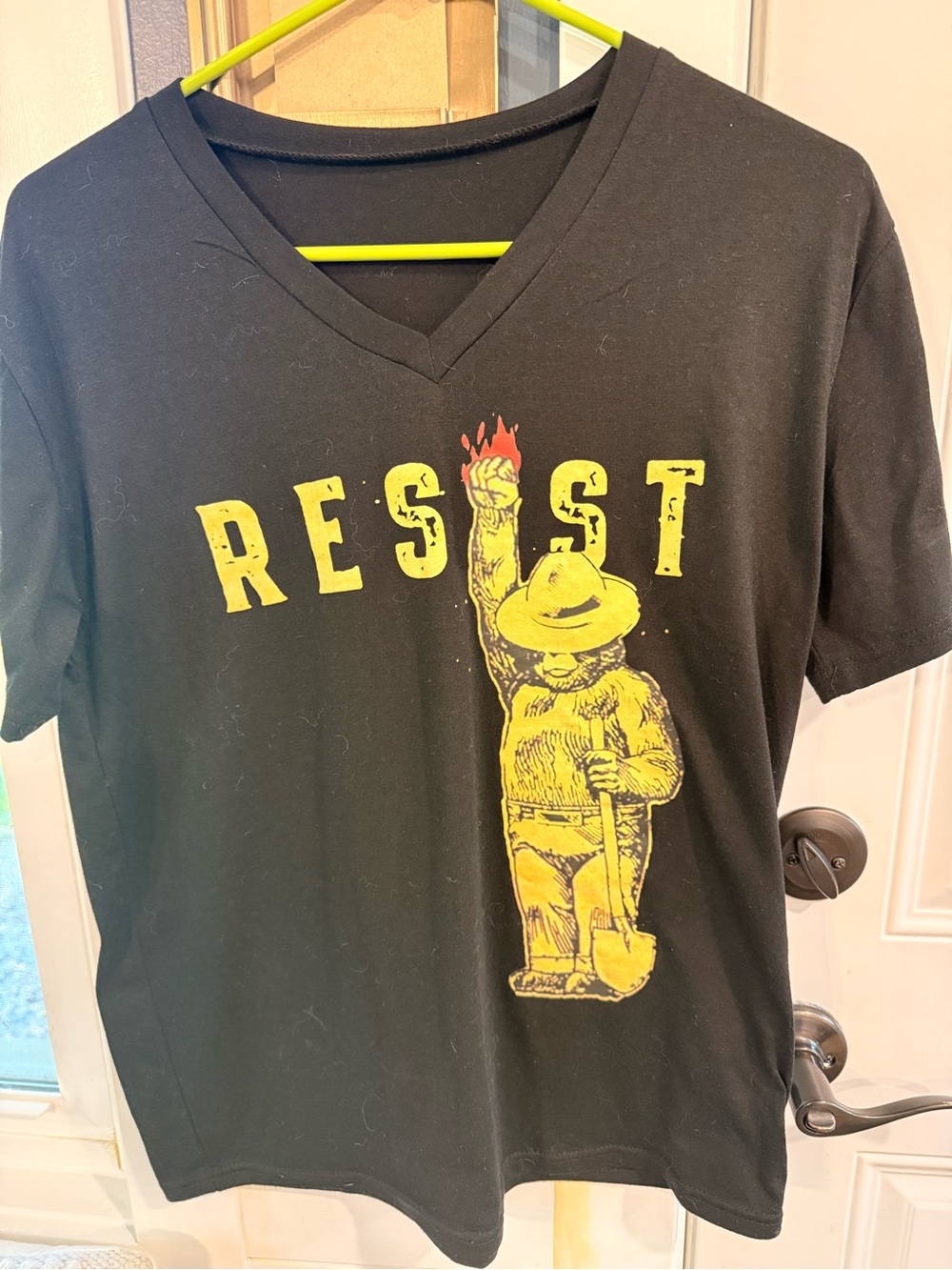H&M Black V-Neck Tee with Yellow 'RESIST' Graphic